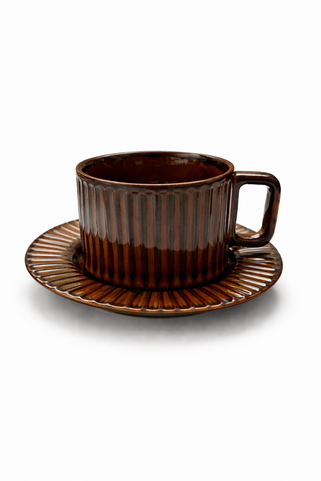Brown ceramic cup and saucer on a white background