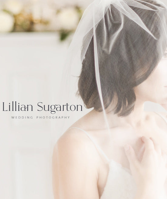 A bridal portrait featuring a woman wearing a sheer white veil and a white strap dress, shown in profile against a bright, softly blurred background. The text 'Lillian Sugarton WEDDING PHOTOGRAPHY' is overlaid on the left side.