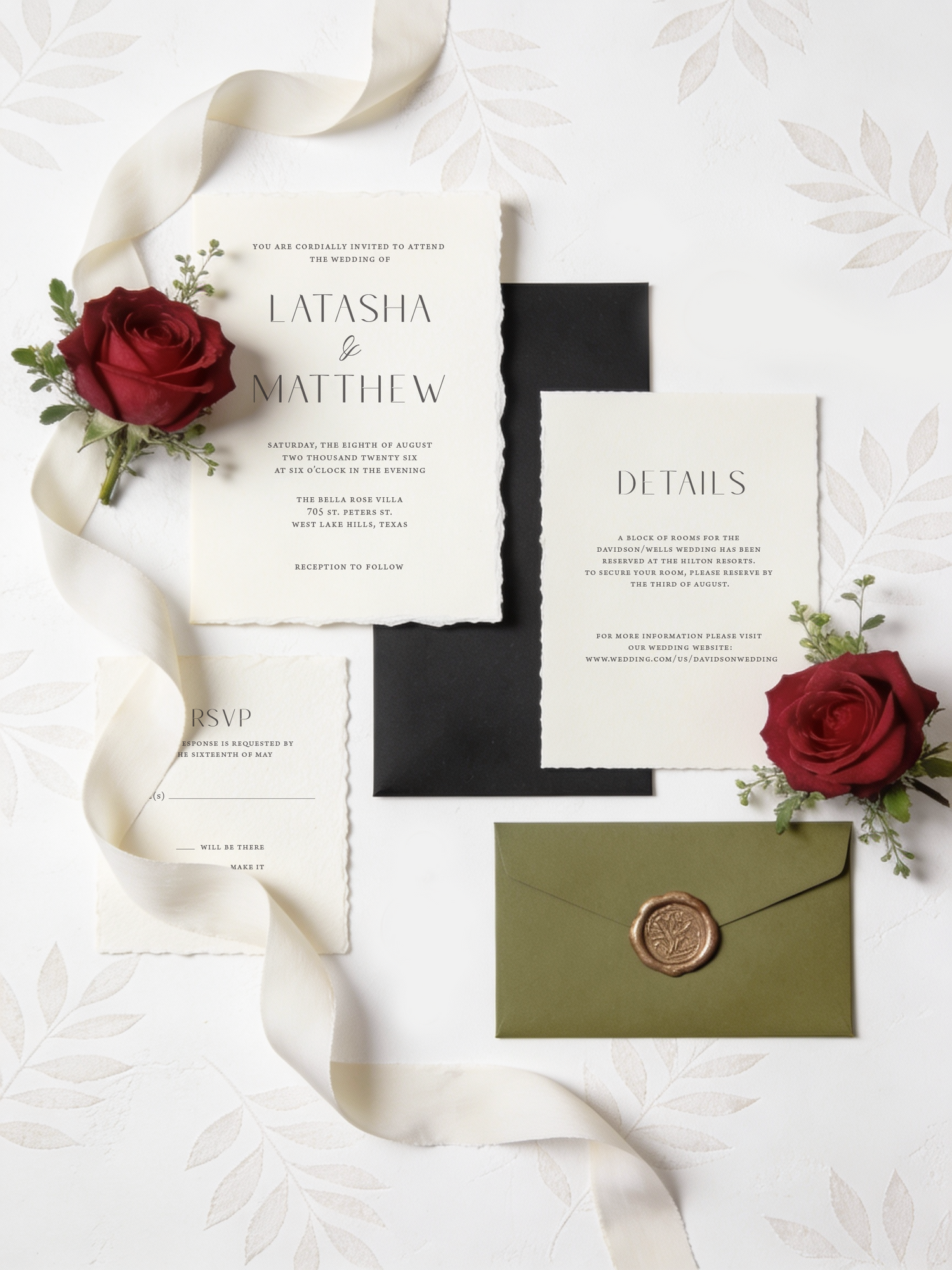 Wedding invitation set with red roses, green envelope, and white ribbon on a light background