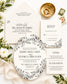A coordinated wedding invitation suite arranged in a flat lay on a light fabric background, with floral greenery, a gold dish, rings, and small cards. The suite includes a main invitation, RSVP card, details card, and a round insert with black floral line art on white.